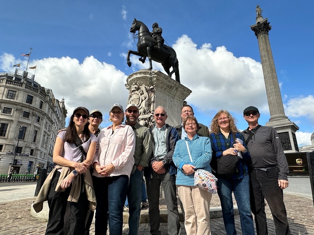 London Christian Tours group at the equestrian statue of Charles I near Trafalgar Square with Nelson’s Column behind