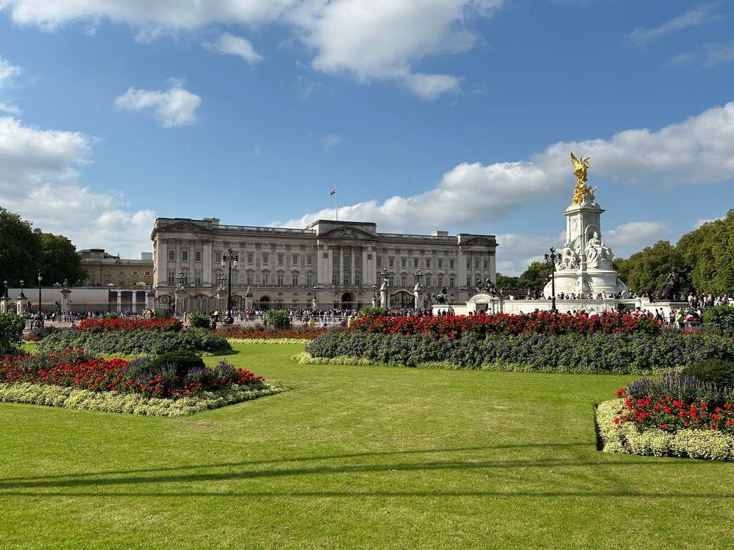 Buckingham Palace with the Victoria Memorial, formal lawns, and flower beds in London