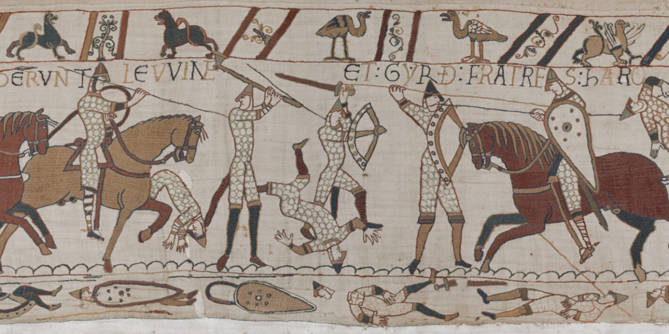 Bayeux Tapestry battle scene showing mounted warriors and fallen figures during the Battle of Hastings